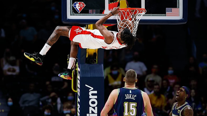 Nov 6, 2021; Denver, Colorado, USA; Houston Rockets guard Jalen Green (0) dunks the ball as Denver Nuggets center Nikola Jokic (15) and forward Will Barton (5) look on in the first quarter at Ball Arena. Mandatory Credit: Isaiah J. Downing-USA TODAY Sports
