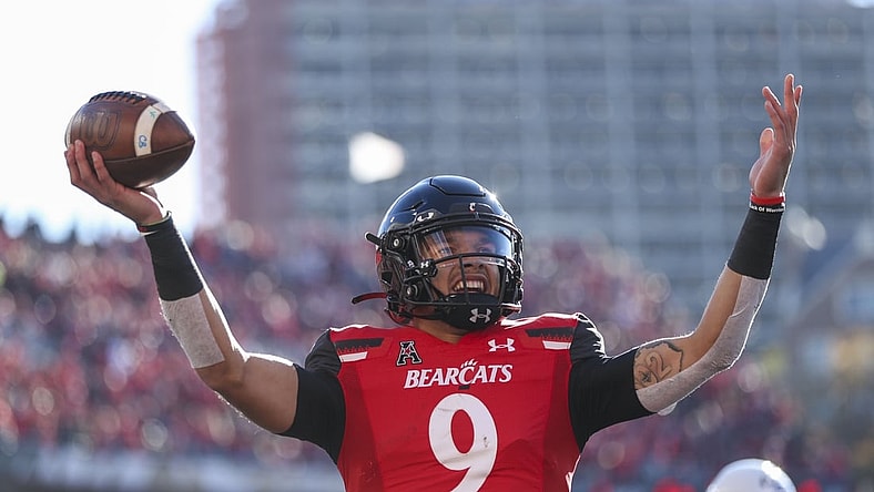 Nov 6, 2021; Cincinnati, Ohio, USA; Cincinnati Bearcats quarterback Desmond Ridder (9) reacts after scoring a touchdown against the Tulsa Golden Hurricane in the first half at Nippert Stadium. Mandatory Credit: Katie Stratman-USA TODAY Sports