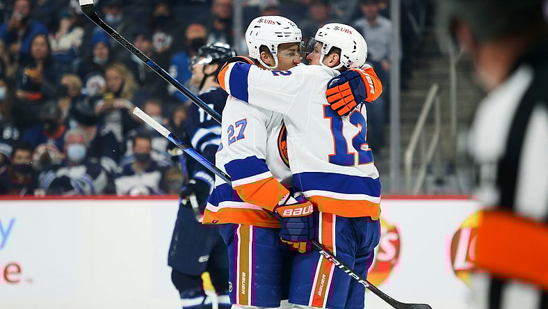 Nov 6, 2021; Winnipeg, Manitoba, CAN; New York Islanders forward Anders Lee (27) celebrates with forward Josh Bailey (12) after scoring a goal against the Winnipeg Jets during the first period at Canada Life Centre. Mandatory Credit: Terrence Lee-USA TODAY Sports