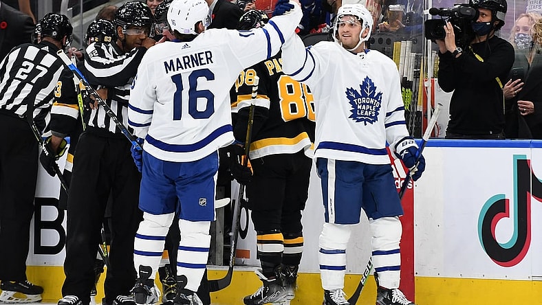 Nov 6, 2021; Toronto, Ontario, CAN;  Toronto Maple Leafs forward Mitch Marner (16) is congratulated for scoring a goal by forward Alexander Kerfoot (15) in the first period against Boston Bruins at Scotiabank Arena. Mandatory Credit: Dan Hamilton-USA TODAY Sports