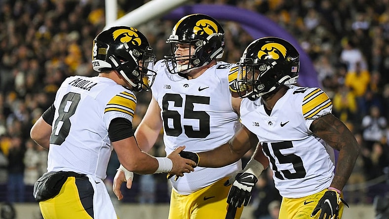Nov 6, 2021; Evanston, Illinois, USA; Iowa Hawkeyes running back Tyler Goodson (15) and Iowa Hawkeyes quarterback Alex Padilla (8) celebrate after the touchdown in the first half against the Northwestern Wildcats at Ryan Field. Mandatory Credit: Quinn Harris-USA TODAY Sports