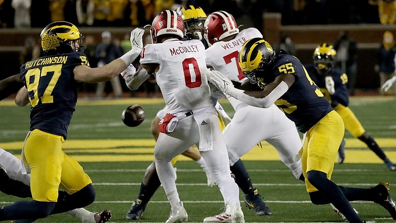 Michigan Wolverines defensive end Aidan Hutchinson (97) and linebacker David Ojabo (55) force a fumble by Indiana Hoosiers quarterback Donaven McCulley (0) during first half action Saturday, Nov. 6, 2021 at Michigan Stadium.

Mich Ind