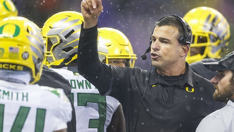 Nov 6, 2021; Seattle, Washington, USA; Oregon Ducks head coach Mario Cristobal speaks with his players during a second quarter timeout against the Washington Huskies at Alaska Airlines Field at Husky Stadium. Mandatory Credit: Joe Nicholson-USA TODAY Sports