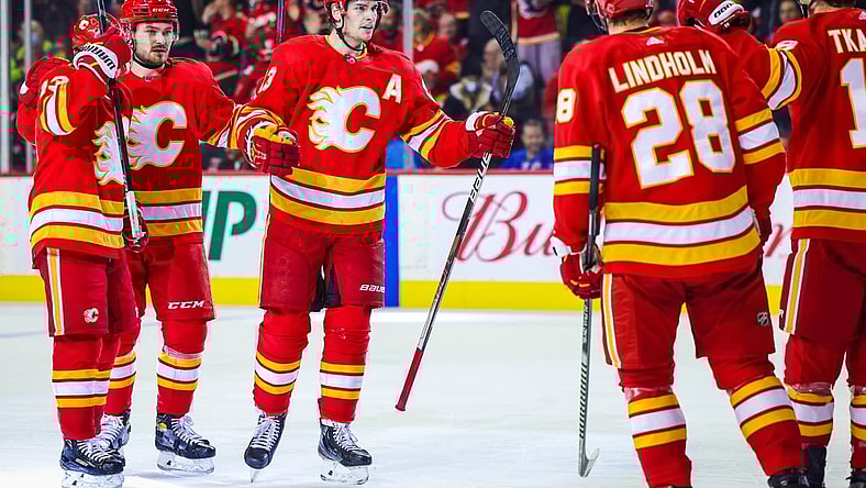 Nov 6, 2021; Calgary, Alberta, CAN; Calgary Flames center Sean Monahan (23) celebrates his goal with teammates against the New York Rangers during the first period at Scotiabank Saddledome. Mandatory Credit: Sergei Belski-USA TODAY Sports