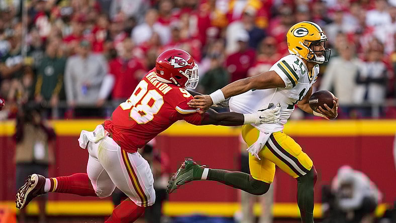 Nov 7, 2021; Kansas City, Missouri, USA; Green Bay Packers quarterback Jordan Love (10) runs the ball against Kansas City Chiefs defensive end Tershawn Wharton (98) during the second quarter at GEHA Field at Arrowhead Stadium. Mandatory Credit: Jay Biggerstaff-USA TODAY Sports