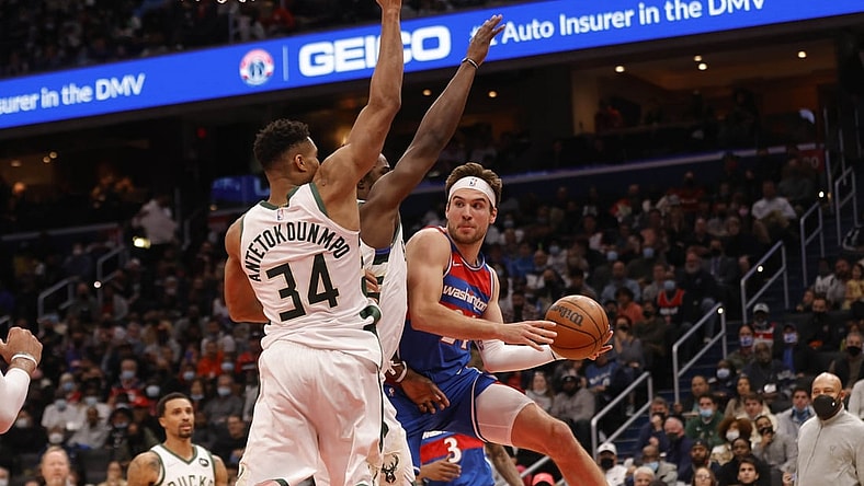 Nov 7, 2021; Washington, District of Columbia, USA; Washington Wizards forward Corey Kispert (24) leaps to pass the ball as Milwaukee Bucks forward Giannis Antetokounmpo (34) defends during the second quarter at Capital One Arena. Mandatory Credit: Geoff Burke-USA TODAY Sports