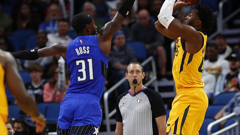 Nov 7, 2021; Orlando, Florida, USA; Utah Jazz guard Donovan Mitchell (45) shoots over Orlando Magic guard Terrence Ross (31) during the second quarter at Amway Center. Mandatory Credit: Kim Klement-USA TODAY Sports