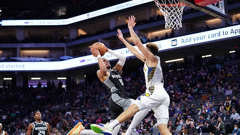Nov 7, 2021; Sacramento, California, USA; Sacramento Kings guard Tyrese Haliburton (0) shoots the ball against Indiana Pacers guard Chris Duarte (3) during the second quarter at Golden 1 Center. Mandatory Credit: Kelley L Cox-USA TODAY Sports