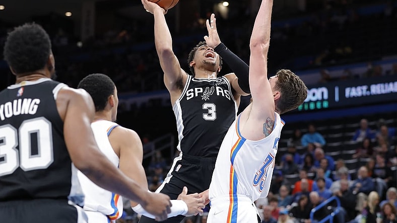 Nov 7, 2021; Oklahoma City, Oklahoma, USA; San Antonio Spurs forward Keldon Johnson (3) goes up for a basket as Oklahoma City Thunder center Mike Muscala (33) defends during the second quarter at Paycom Center. Mandatory Credit: Alonzo Adams-USA TODAY Sports