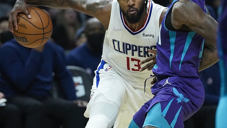 Nov 7, 2021; Los Angeles, California, USA; LA Clippers guard Paul George (13) drives the baseline defended by Charlotte Hornets guard Terry Rozier (3) in the second quarter at Staples Center. Mandatory Credit: Robert Hanashiro-USA TODAY Sports