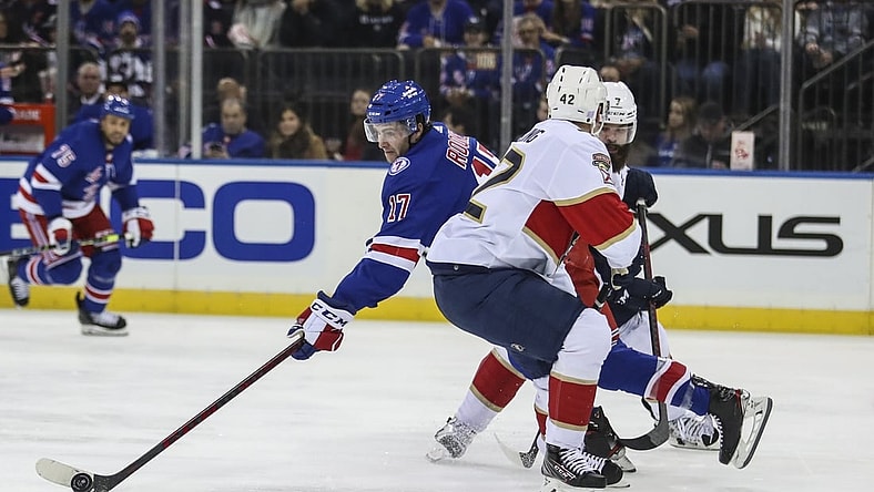 Nov 8, 2021; New York, New York, USA;  New York Rangers center Kevin Rooney (17) controls the puck in the second period at Madison Square Garden. Mandatory Credit: Wendell Cruz-USA TODAY Sports