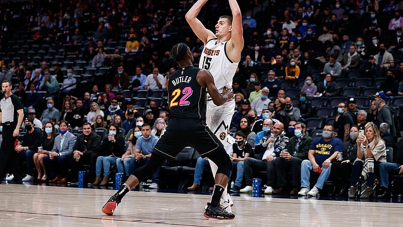 Nov 8, 2021; Denver, Colorado, USA; Denver Nuggets center Nikola Jokic (15) looks to pass the ball as Miami Heat forward Jimmy Butler (22) guards in the first quarter at Ball Arena. Mandatory Credit: Isaiah J. Downing-USA TODAY Sports