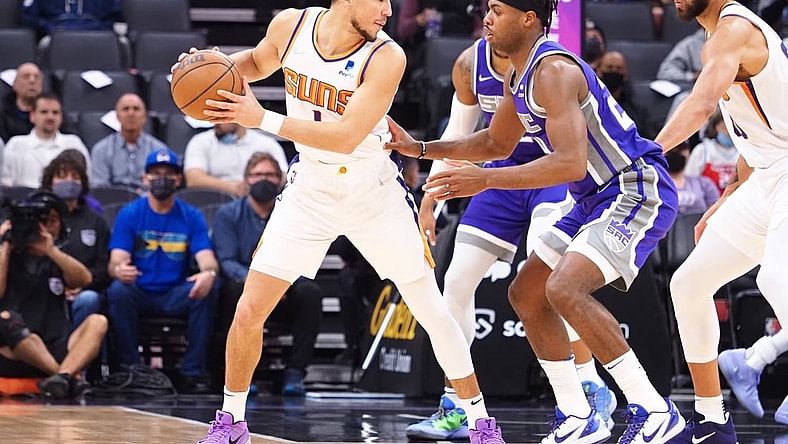 Nov 8, 2021; Sacramento, California, USA; Phoenix Suns guard Devin Booker (1) controls the ball against Sacramento Kings guard Buddy Hield (24) during the order quarter at Golden 1 Center. Mandatory Credit: Kelley L Cox-USA TODAY Sports