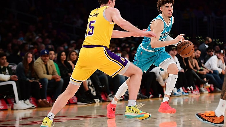 Nov 8, 2021; Los Angeles, California, USA; Charlotte Hornets guard LaMelo Ball (2) moves the ball against Los Angeles Lakers guard Austin Reaves (15) during the first half at Staples Center. Mandatory Credit: Gary A. Vasquez-USA TODAY Sports