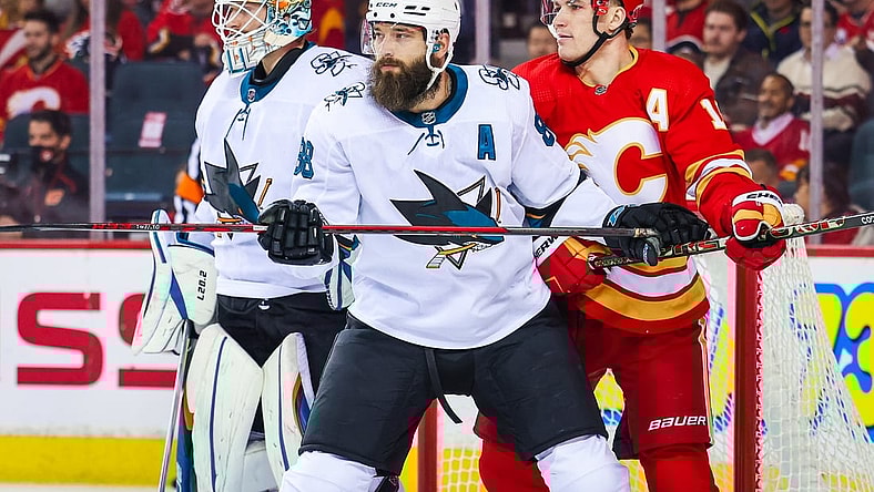 Nov 9, 2021; Calgary, Alberta, CAN; San Jose Sharks defenseman Brent Burns (88) and Calgary Flames left wing Matthew Tkachuk (19) fight for position in front of San Jose Sharks goaltender Adin Hill (33) during the first period at Scotiabank Saddledome. Mandatory Credit: Sergei Belski-USA TODAY Sports