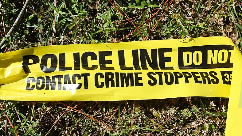 A ripped piece of police crime scene tape.