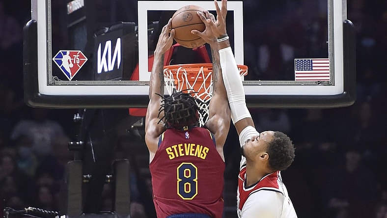 Nov 10, 2021; Cleveland, Ohio, USA; Cleveland Cavaliers forward Lamar Stevens (8) dunks the ball against Washington Wizards center Daniel Gafford (21) in the second quarter at Rocket Mortgage FieldHouse. Mandatory Credit: David Richard-USA TODAY Sports