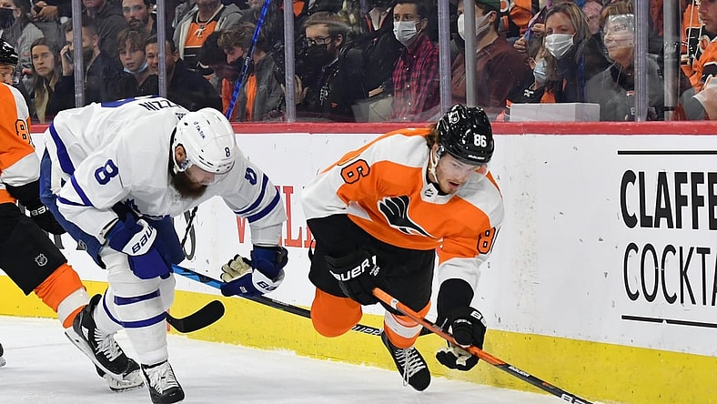 Nov 10, 2021; Philadelphia, Pennsylvania, USA; Philadelphia Flyers left wing Joel Farabee (86) is tripped up by Toronto Maple Leafs defenseman Jake Muzzin (8) during the first period at Wells Fargo Center. Mandatory Credit: Eric Hartline-USA TODAY Sports