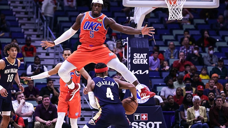 Nov 10, 2021; New Orleans, Louisiana, USA;  Oklahoma City Thunder forward Luguentz Dort (5) tries to block. Shot by New Orleans Pelicans guard Devonte' Graham (4) during the first half at Smoothie King Center. Mandatory Credit: Stephen Lew-USA TODAY Sports
