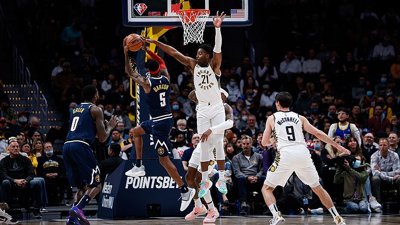 Nov 10, 2021; Denver, Colorado, USA; Denver Nuggets forward Will Barton (5) attempts a shot against Indiana Pacers guard Kelan Martin (21) and forward Torrey Craig (13) as forward JaMychal Green (0) and guard T.J. McConnell (9) defend in the second quarter at Ball Arena. Mandatory Credit: Isaiah J. Downing-USA TODAY Sports