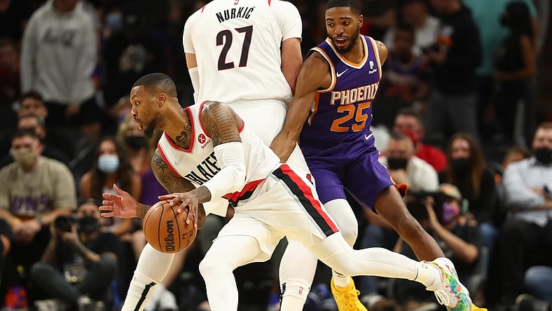 Nov 10, 2021; Phoenix, Arizona, USA; Portland Trail Blazers guard Damian Lillard (0) moves the ball against Phoenix Suns forward Mikal Bridges (25) in the first half at Footprint Center. Mandatory Credit: Mark J. Rebilas-USA TODAY Sports