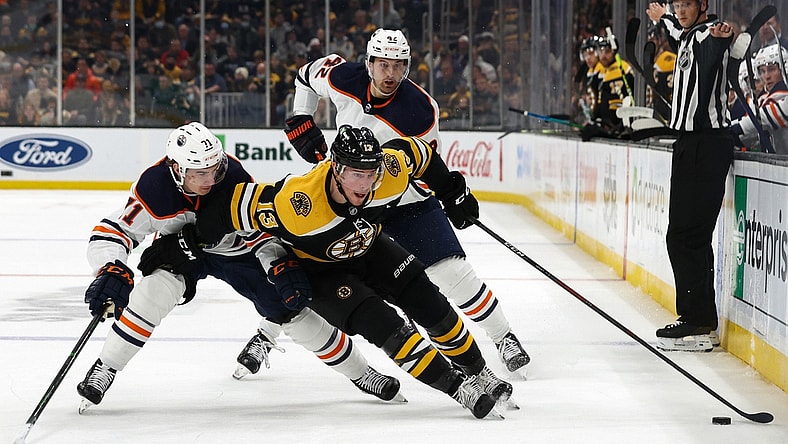 Nov 11, 2021; Boston, Massachusetts, USA; Boston Bruins center Charlie Coyle (13) tries to go around Edmonton Oilers center Ryan McLeod (71) during the first period at TD Garden. Mandatory Credit: Winslow Townson-USA TODAY Sports