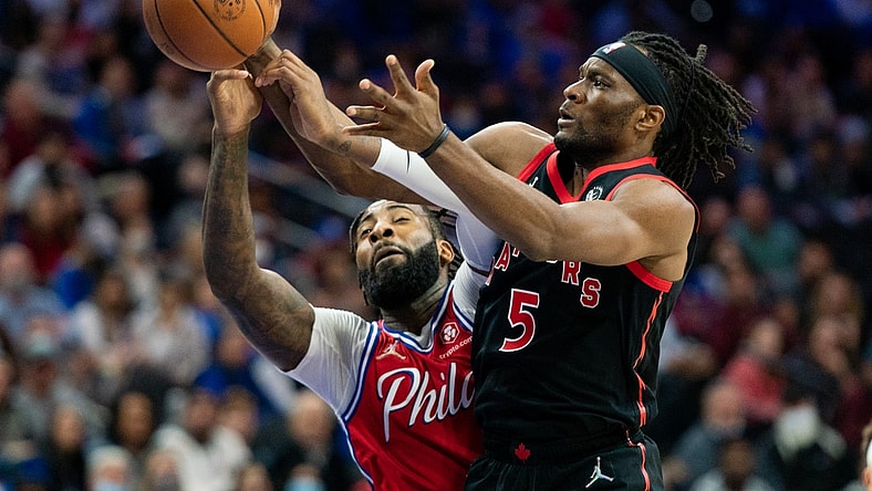 Nov 11, 2021; Philadelphia, Pennsylvania, USA; Toronto Raptors forward Precious Achiuwa (5) and Philadelphia 76ers center Andre Drummond (1) battle for a rebound during the second quarter at Wells Fargo Center. Mandatory Credit: Bill Streicher-USA TODAY Sports