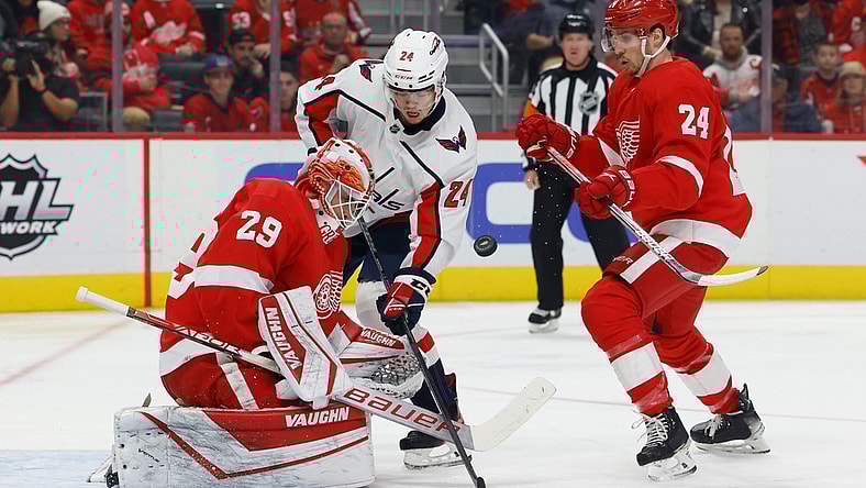 Nov 11, 2021; Detroit, Michigan, USA;  Detroit Red Wings goaltender Thomas Greiss (29) makes a save in front of Washington Capitals center Connor McMichael (24) and center Pius Suter (24) in the first period at Little Caesars Arena. Mandatory Credit: Rick Osentoski-USA TODAY Sports