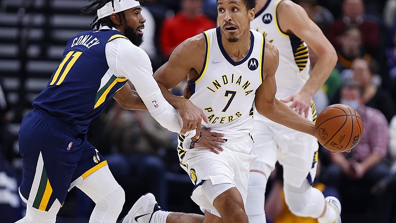 Nov 11, 2021; Salt Lake City, Utah, USA; Indiana Pacers guard Malcolm Brogdon (7) looks to pass against Utah Jazz guard Mike Conley (11) in the first quarter at Vivint Arena. Mandatory Credit: Jeffrey Swinger-USA TODAY Sports