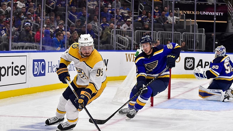 Nov 11, 2021; St. Louis, Missouri, USA;  Nashville Predators center Matt Duchene (95) handles the puck as St. Louis Blues center Tyler Bozak (21) defends during the third period at Enterprise Center. Mandatory Credit: Jeff Curry-USA TODAY Sports