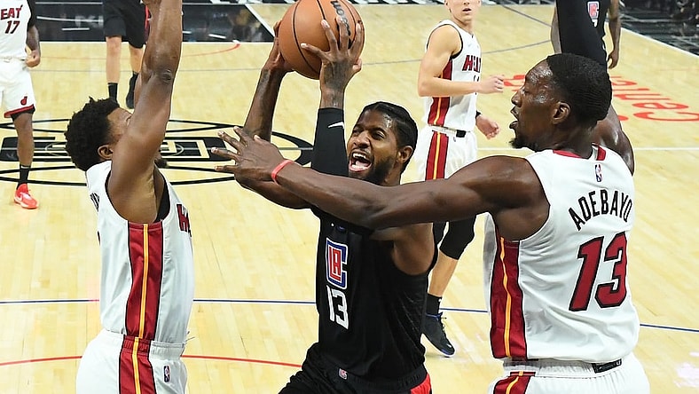 Nov 11, 2021; Los Angeles, California, USA;  Los Angeles Clippers guard Paul George (13) goes up for a basket as he is defended by Miami Heat guard Kyle Lowry (7) and center Bam Adebayo (13) in the first half at Staples Center. Mandatory Credit: Jayne Kamin-Oncea-USA TODAY Sports