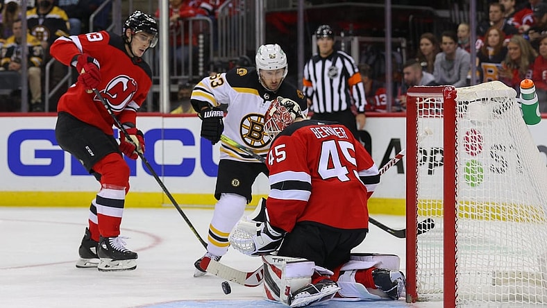 Nov 13, 2021; Newark, New Jersey, USA; New Jersey Devils goaltender Jonathan Bernier (45) makes a save while Boston Bruins center Brad Marchand (63) looks for the rebound during the first period at Prudential Center. Mandatory Credit: Ed Mulholland-USA TODAY Sports