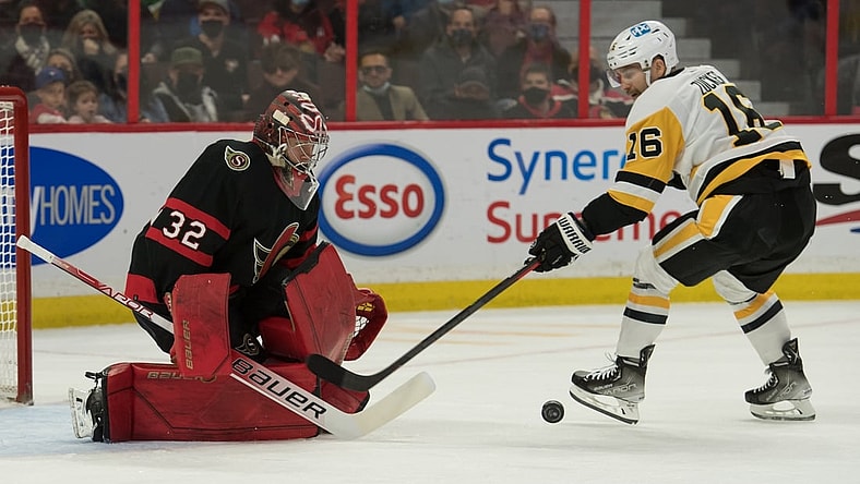 Nov 13, 2021; Ottawa, Ontario, CAN; Ottawa Senators goalie Filip Gustavsson (32) makes a save on a shot from Pittsburgh Penguins left wing Jason Zucker (16) in the first period at the Canadian Tire Centre. Mandatory Credit: Marc DesRosiers-USA TODAY Sports