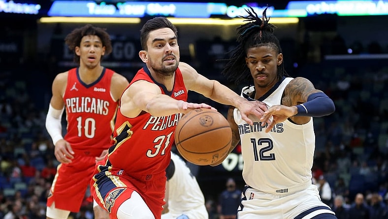 Nov 13, 2021; New Orleans, Louisiana, USA; New Orleans Pelicans guard Tomas Satoransky (31) and Memphis Grizzlies guard Ja Morant (12) battle for the ball in the first quarter at the Smoothie King Center. Mandatory Credit: Chuck Cook-USA TODAY Sports