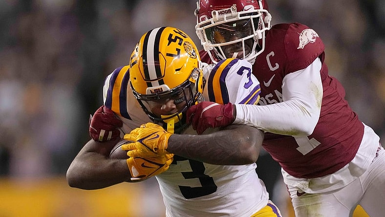 Nov 13, 2021; Baton Rouge, Louisiana, USA; LSU Tigers running back Tyrion Davis-Price (3) runs the ball against Arkansas Razorbacks defensive back Joe Foucha (7) in the first half at Tiger Stadium. Mandatory Credit: Kirby Lee-USA TODAY Sports