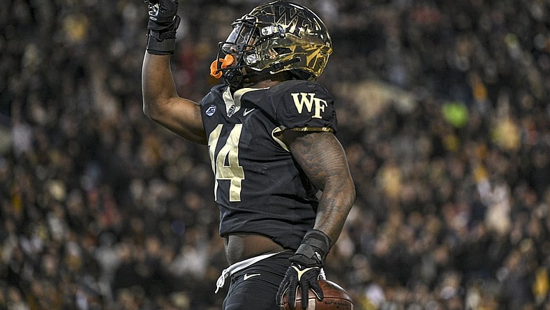 Nov 13, 2021; Winston-Salem, North Carolina, USA; Wake Forest Demon Deacons running back Justice Ellison (14) celebrates after scoring a touchdown against the North Carolina State Wolfpack during the first half at Truist Field. Mandatory Credit: William Howard-USA TODAY Sports