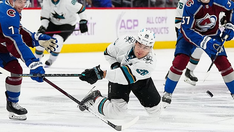 Nov 13, 2021; Denver, Colorado, USA; San Jose Sharks right wing Timo Meier (28) falls as he attempts a shot on goal against the Colorado Avalanche in the first period at Ball Arena. Mandatory Credit: Ron Chenoy-USA TODAY Sports