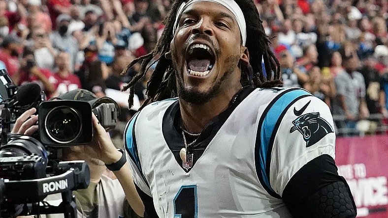 Nov 14, 2021; Glendale, Arizona, USA; Carolina Panthers quarterback Cam Newton (1) yells "I'm back!" after scoring a rushing touchdown against the Arizona Cardinals in the first half at State Farm Stadium.  Mandatory Credit: Rob Schumacher-Arizona Republic via USA TODAY Network