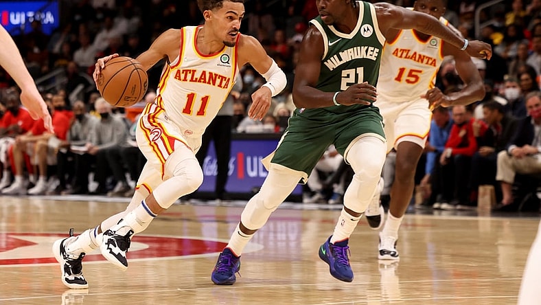 Nov 14, 2021; Atlanta, Georgia, USA; Atlanta Hawks guard Trae Young (11) drives against Milwaukee Bucks guard Jrue Holiday (21) during the second quarter at State Farm Arena. Mandatory Credit: Jason Getz-USA TODAY Sports