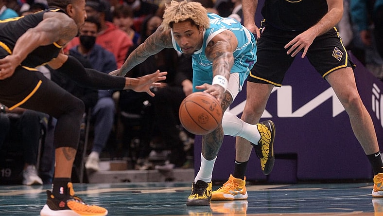 Nov 14, 2021; Charlotte, North Carolina, USA;  Charlotte Hornets guard forward Kelly Oubre Jr. (12) goes after a loose ball during the first half against the Golden State Warriors at the Spectrum Center. Mandatory Credit: Sam Sharpe-USA TODAY Sports