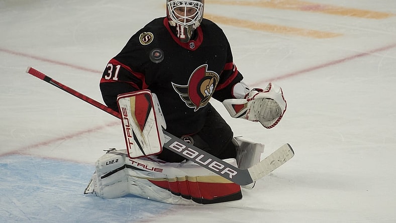 Nov 14, 2021; Ottawa, Ontario, CAN; Ottawa Senators goalie Anton Forsberg (31) makes a save in the third period against the Calgary Flames at the Canadian Tire Centre. Mandatory Credit: Marc DesRosiers-USA TODAY Sports