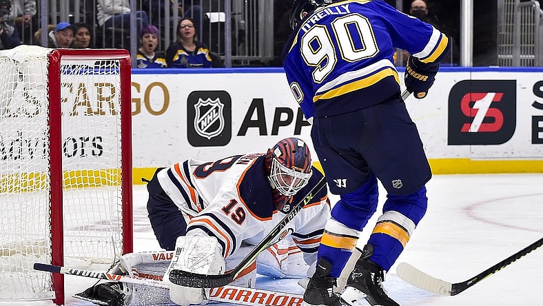 Nov 14, 2021; St. Louis, Missouri, USA;  Edmonton Oilers goaltender Mikko Koskinen (19) defends the net against St. Louis Blues center Ryan O'Reilly (90) during the second period at Enterprise Center. Mandatory Credit: Jeff Curry-USA TODAY Sports