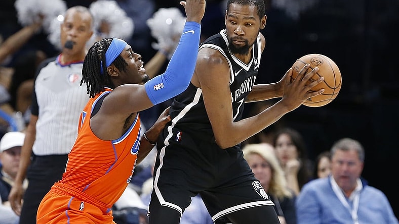 Nov 14, 2021; Oklahoma City, Oklahoma, USA; Oklahoma City Thunder forward Luguentz Dort (5) defends Brooklyn Nets forward Kevin Durant (7) on a play during the second half at Paycom Center. Brooklyn won 120-96. Mandatory Credit: Alonzo Adams-USA TODAY Sports