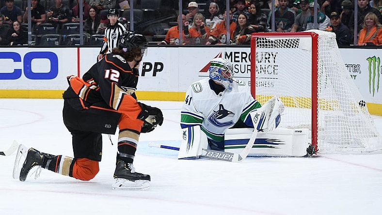 Nov 14, 2021; Anaheim, California, USA; Anaheim Ducks left wing Sonny Milano (12) scores a goal past Vancouver Canucks goaltender Jaroslav Halak (41) during the second period at Honda Center. Mandatory Credit: Orlando Ramirez-USA TODAY Sports