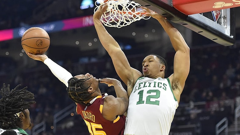 Nov 15, 2021; Cleveland, Ohio, USA; Boston Celtics forward Grant Williams (12) defends a shot by Cleveland Cavaliers forward Isaac Okoro (35) in the second quarter at Rocket Mortgage FieldHouse. Mandatory Credit: David Richard-USA TODAY Sports