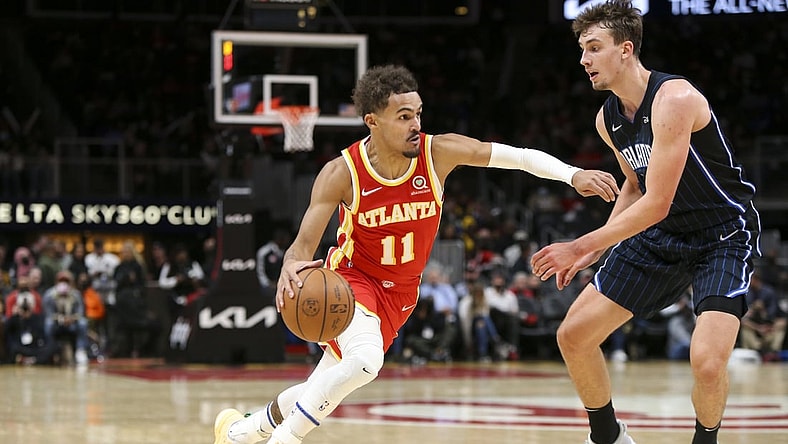Nov 15, 2021; Atlanta, Georgia, USA; Atlanta Hawks guard Trae Young (11) is defended by Orlando Magic forward Franz Wagner (22) in the second quarter at State Farm Arena. Mandatory Credit: Brett Davis-USA TODAY Sports