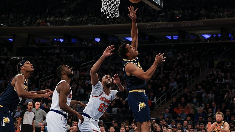Nov 15, 2021; New York, New York, USA; Indiana Pacers guard Malcolm Brogdon (7) shoots the ball as New York Knicks center Taj Gibson (67) defends during the first half at Madison Square Garden. Mandatory Credit: Vincent Carchietta-USA TODAY Sports