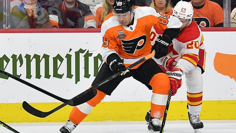 Nov 16, 2021; Philadelphia, Pennsylvania, USA; Philadelphia Flyers right wing Cam Atkinson (89) battle for the puck with Calgary Flames center Blake Coleman (20) during the first period at Wells Fargo Center. Mandatory Credit: Eric Hartline-USA TODAY Sports