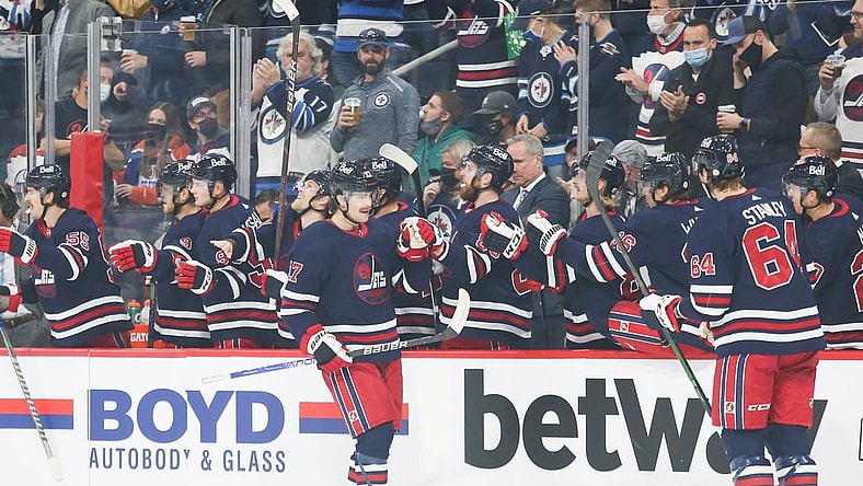 Nov 16, 2021; Winnipeg, Manitoba, CAN;  Winnipeg Jets forward Adam Lowry (17) is congratulated by his team mates on his goal against the Edmonton Oilers during the first period at Canada Life Centre. Mandatory Credit: Terrence Lee-USA TODAY Sports