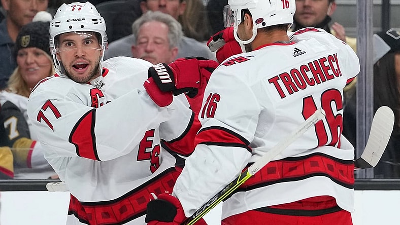 Nov 16, 2021; Las Vegas, Nevada, USA; Carolina Hurricanes defenseman Tony DeAngelo (77) celebrates with Carolina Hurricanes center Vincent Trocheck (16) after scoring a first period goal against the Vegas Golden Knights at T-Mobile Arena. Mandatory Credit: Stephen R. Sylvanie-USA TODAY Sports